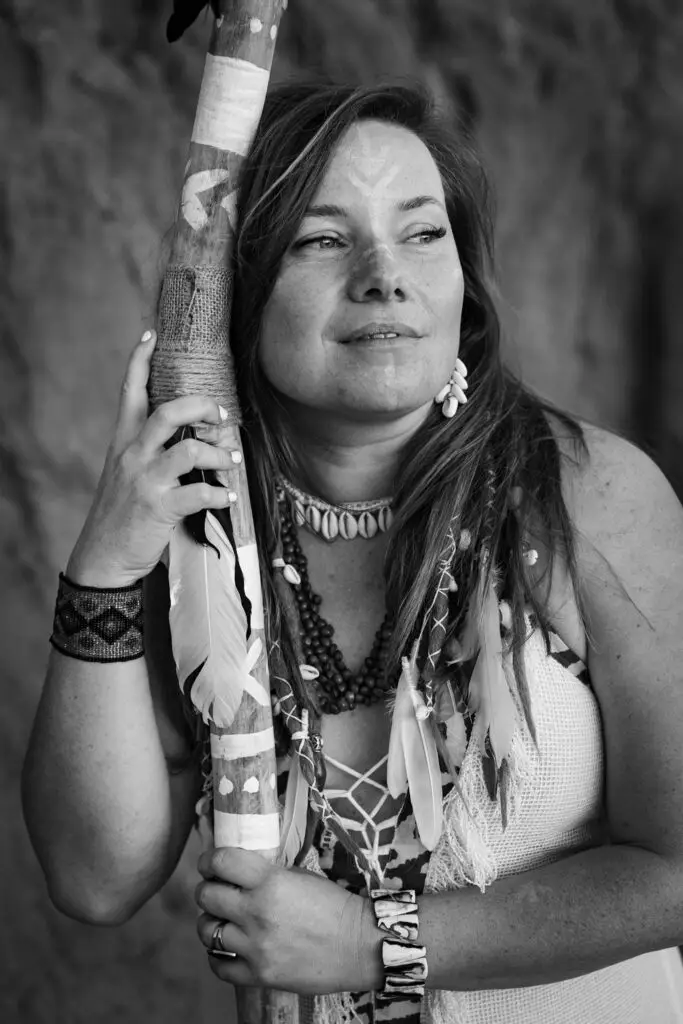 Female entrepreneur holding a staff, symbolizing strength and wild authenticity in leadership